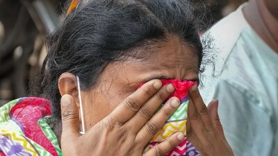 A woman reacts as she is still unable to find her relatives two days after the three trains collided with one after another that left at least 275 dead and above 1,000 injured, in Balasore, Odisha, on Sunday, (PTI) A woman reacts as she is still unable to find her relatives two days after the three trains collided with one after another that left at least 275 dead and above 1,000 injured, in Balasore, Odisha, on Sunday, (PTI)