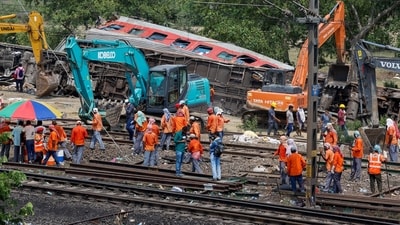 Heavy machinery remove damaged coaches from the railway tracks at the site of a train collision following the accident in Balasore district in Odisha. (Reuters)