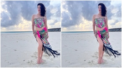 Sunny decked up in an off-shoulder corset patterned cropped top with pink and green floral patterns and a monochrome cheetah printed on it, decorated in white shells at the borders. She further teamed it with a matching satin sarong. (Instagram/@sunnyleone) Sunny decked up in an off-shoulder corset patterned cropped top with pink and green floral patterns and a monochrome cheetah printed on it, decorated in white shells at the borders. She further teamed it with a matching satin sarong. (Instagram/@sunnyleone)
