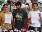 Protesting wrestlers Vinesh Phogat, Bajrang Punia and Sakshi Malik at Jantar Mantar in New Delhi on May 14. (Vipin Kumar/ Hindustan Times) Protesting wrestlers Vinesh Phogat, Bajrang Punia and Sakshi Malik at Jantar Mantar in New Delhi on May 14. (Vipin Kumar/ Hindustan Times)