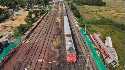 A train running past derailed coaches after the services resumed. (PTI) A train running past derailed coaches after the services resumed. (PTI)