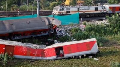A train moves past damaged coaches, after the tracks were restored, at the site of a train collision. (REUTERS)