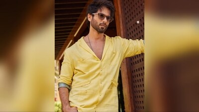Shahid Kapoor's shirt boasts a V-neck, pocket detailing, buttoned front, folded sleeves, and grey accents on the sleeve borders. He stylishly pairs it with blue washed denim jeans. (Instagram/@shahidkapoor ) Shahid Kapoor's shirt boasts a V-neck, pocket detailing, buttoned front, folded sleeves, and grey accents on the sleeve borders. He stylishly pairs it with blue washed denim jeans. (Instagram/@shahidkapoor )