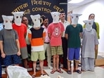 Narcotics Control Bureau officials with people arrested after the busting of a suspected drugs trafficking network operating on the dark web, on Tuesday, June 6, 2023. (PTI)