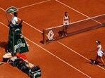 Belarus' Aryna Sabalenka waits at the net after winning her quarter final match as Ukraine's Elina Svitolina walks past