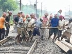Workers restore railway tracks at the site of collision in Odisha’s Balasore district on Tuesday. (PTI)