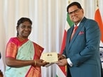 President Droupadi Murmu being presented special covers of stamps to mark 150 years of arrival of Indians in Suriname by President of Suriname Chan Santokhi, in Suriname, Monday. President Droupadi Murmu being presented special covers of stamps to mark 150 years of arrival of Indians in Suriname by President of Suriname Chan Santokhi, in Suriname, Monday.