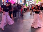 Woman tapping her feet energetically to Aamir Khan and Gracy Singh’s Radha Kaise Na Jale at Times Square in New York.
