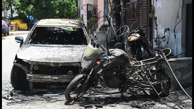 A car and two bikes were burnt after they caught fire due to a spark from an electric pole at a colony in Sector 40, in Gurugram on Tuesday. (Parveen Kumar/HT) A car and two bikes were burnt after they caught fire due to a spark from an electric pole at a colony in Sector 40, in Gurugram on Tuesday. (Parveen Kumar/HT)