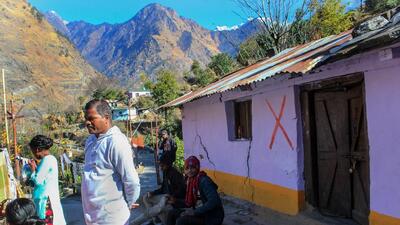 A red cross is marked on an unsafe building by the authorities after cracks appeared at the landslide affected area of Joshimath, in Chamoli district of Uttarakhand. (PTI)