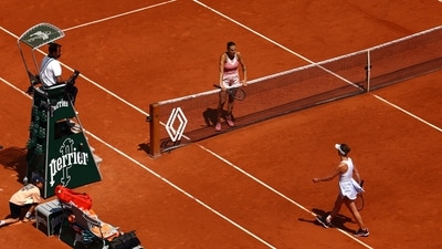 Belarus' Aryna Sabalenka waits at the net after winning her quarter final match as Ukraine's Elina Svitolina walks past (REUTERS)