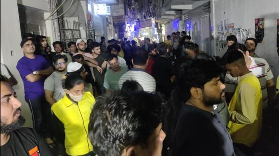 People outside the house of the two siblings who suffocated to death in Delhi’s Jamia Nagar area on Tuesday evening. (HT photo)