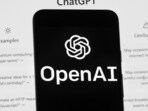 The OpenAI logo is seen on a mobile phone in front of a computer screen which displays the ChatGPT home Screen. The draft bill is not final and lawyers say it will likely take years to come into force. (AP) The OpenAI logo is seen on a mobile phone in front of a computer screen which displays the ChatGPT home Screen. The draft bill is not final and lawyers say it will likely take years to come into force. (AP)