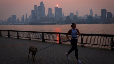A woman jogs with a dog along the Hudson River shortly after sunrise, as haze and smoke caused by wildfires in Canada hang over the Manhattan skyline, in New York, on June 7. Environment Canada, the government-run weather agency told Reuters that wildfire smoke can harm health even at low concentrations, and people with lung or heart diseases, as well as older adults, children, and pregnant women, were at higher health risk from wildfire smoke, (Mike Segar / Reuters) A woman jogs with a dog along the Hudson River shortly after sunrise, as haze and smoke caused by wildfires in Canada hang over the Manhattan skyline, in New York, on June 7. Environment Canada, the government-run weather agency told Reuters that wildfire smoke can harm health even at low concentrations, and people with lung or heart diseases, as well as older adults, children, and pregnant women, were at higher health risk from wildfire smoke, (Mike Segar / Reuters)