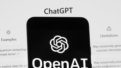 The OpenAI logo is seen on a mobile phone in front of a computer screen which displays the ChatGPT home Screen. The draft bill is not final and lawyers say it will likely take years to come into force. (AP) The OpenAI logo is seen on a mobile phone in front of a computer screen which displays the ChatGPT home Screen. The draft bill is not final and lawyers say it will likely take years to come into force. (AP)