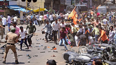 Security personnel disperse people protesting against the alleged use of Tipu Sultan's image in objectionable social media posts, in Kolhapur district. (PTI) Security personnel disperse people protesting against the alleged use of Tipu Sultan's image in objectionable social media posts, in Kolhapur district. (PTI)