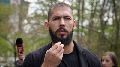 Andrew Tate touches his beard after leaving the Bucharest Tribunal, in Bucharest, Romania, Friday, April 21, 2023. The brothers' attendance on Friday comes after they won an appeal on March 31 to be moved from police custody to house arrest, where they will remain until at least April 29. (AP Photo/Vadim Ghirda) (AP)
