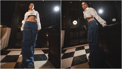 Tamannaah wore a super cropped cream-coloured shirt featuring a midriff-baring hem length, collared neckline, a single button closure, full-length sleeves, a vertical pinstripe design, and an oversized silhouette. She wore the blouse on top of a black lacy bralette. (Instagram) Tamannaah wore a super cropped cream-coloured shirt featuring a midriff-baring hem length, collared neckline, a single button closure, full-length sleeves, a vertical pinstripe design, and an oversized silhouette. She wore the blouse on top of a black lacy bralette. (Instagram)