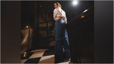 Tamannaah styled the top with dark blue-coloured denim cargo pants featuring a mid-rise waist, a flared hem, a relaxed fitting, and several pocket detailing. For accessories, she picked gold-toned layered chains, statement earrings, rings, and kitten heels. (Instagram) Tamannaah styled the top with dark blue-coloured denim cargo pants featuring a mid-rise waist, a flared hem, a relaxed fitting, and several pocket detailing. For accessories, she picked gold-toned layered chains, statement earrings, rings, and kitten heels. (Instagram)