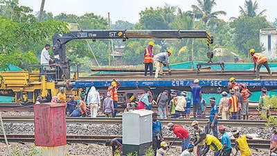 Workers restore railway tracks at the site where the recent triple-train accident happened, near Bahanaga Bazar railway station in Odisha’s Balasore district, on Wednesday. (PTI) Workers restore railway tracks at the site where the recent triple-train accident happened, near Bahanaga Bazar railway station in Odisha’s Balasore district, on Wednesday. (PTI)