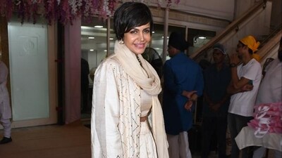 Mandira Bedi opted for a cream cropped top under a long jacket and skirt. She also wrapped a dupatta around her neck. Mandira Bedi opted for a cream cropped top under a long jacket and skirt. She also wrapped a dupatta around her neck.
