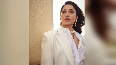 Tamannaah added stylish accessories to complement her classy ensemble, including a chic big pearl choker necklace and a golden chain necklace with a large circular pendant. The statement pearl drop earrings further enhanced her overall look. (Instagram/@tamannaahspeaks) Tamannaah added stylish accessories to complement her classy ensemble, including a chic big pearl choker necklace and a golden chain necklace with a large circular pendant. The statement pearl drop earrings further enhanced her overall look. (Instagram/@tamannaahspeaks)