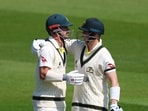Australia's Travis Head celebrates reaching his 150 with Steve Smith.
