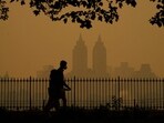 People walk in Central Park as smoke from wildfires in Canada cause hazy conditions in New York City on June 7, 2023. Smoke from Canada's wildfires has engulfed the Northeast and Mid-Atlantic regions of the US, raising concerns over the harms of persistent poor air quality.