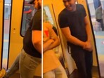 The image shows two men travelling in Delhi Metro stopping a door from closing. The image shows two men travelling in Delhi Metro stopping a door from closing.