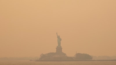 The Statue of Liberty, covered in a haze-filled sky, is photographed from the Staten Island Ferry. (AP)