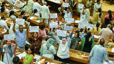 BJP councillors hold placards and shout slogans during the MCD House meeting on Thursday. (Raj K Raj/HT Photo) BJP councillors hold placards and shout slogans during the MCD House meeting on Thursday. (Raj K Raj/HT Photo)