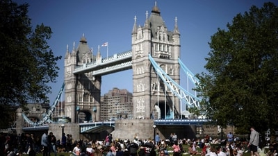 People enjoy the sunshine and the warm weather on the grass by Tower Bridge, in central London. The site of British monarch coronations, London has turned out to be the 4th most expensive city for expats. This comes amid as the UK inflation is hovering around a 40-year high. The country's annual inflation slowed to a 13-month low in April, but remains elevated at 8.7 percent as soaring food prices offset weaker energy costs. (AFP)