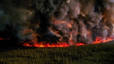Smoke billows upwards from a planned ignition by firefighters tackling the Donnie Creek Complex wildfire south of Fort Nelson, British Columbia, Canada on June 3. (REUTERS)