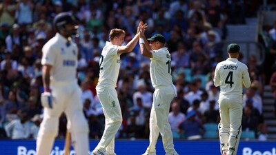Australia's Cameron Green celebrates after taking the wicket of India's Cheteshwar Pujara with Scott Boland (Reuters)