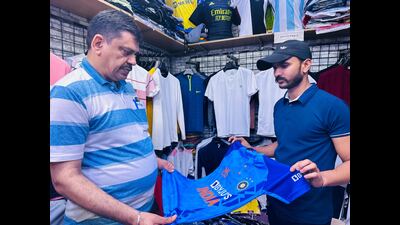 Delhiite Sunil Sharma (L), a retired engineer, buys a jersey of Team India at Palika Bazar, for his grandson, for ₹200. Delhiite Sunil Sharma (L), a retired engineer, buys a jersey of Team India at Palika Bazar, for his grandson, for ₹200.
