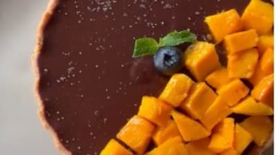 4. Mango Chocolate sea salt tart by Chef Govind Nayak: Ingredients for tart&nbsp;-Icing sugar 100 gm, Butter 120 gm, Flour 150 gm.&nbsp;&nbsp;Method - Make a stiff dough using all the above ingredients. Line the tart mould with butter, place the dough in mould and shape it in the mould.&nbsp;Bake it at 160 degree Celsius 10 minutes. Ingredients for filling&nbsp;-&nbsp;Dark chocolate 125 gm, Callebut Chocolate 100 gm,&nbsp;Cream 250 gm.&nbsp;Method -&nbsp;Make a ganache out of the above filling, fill in the disposable piping bag and keep it to set for some time.&nbsp;&nbsp;Ingredients for Caramel sauce&nbsp;-&nbsp;Sugar 80 gm, Butter&nbsp;50 gm,&nbsp;Cream 100 gm,&nbsp;Seasalt 3 gm.&nbsp;Method -&nbsp;Dissolve the sugar in a pan to make a caramel consistent and mix rest of ingredient well to get a sauce consistency. Assembly - Take the above tart.&nbsp;Add the caramel sauce, let it settle down, add the chocolate ganache, keep the tart in fridge to get the consistency of ganache right, remove from fridge in 15 minutes, dice the Alphonso Mango put above ganache, sprinkle sea salt, garnish with fresh berries. &nbsp; (Chef Govind Nayak)
