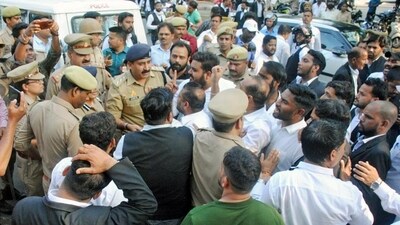 Police personnel and lawyers outside the court premises in Lucknow after the murder of gangster Sanjeev Maheshwari alias Jeeva on Wednesday. (ANI PHOTO) Police personnel and lawyers outside the court premises in Lucknow after the murder of gangster Sanjeev Maheshwari alias Jeeva on Wednesday. (ANI PHOTO)