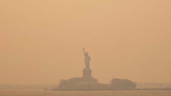 The Statue of Liberty, covered in a haze-filled sky, is photographed from the Staten Island Ferry.(AP)