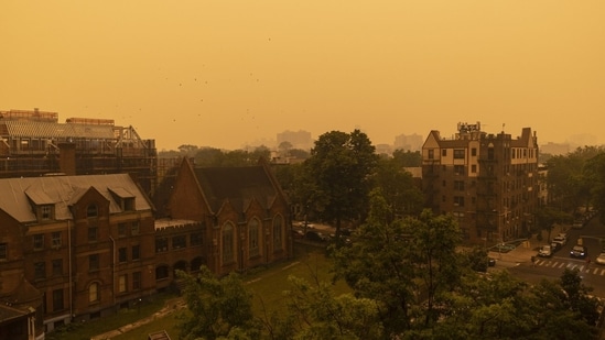 Buildings shrouded in smoke from Canada wildfires in the Crown Heights neighborhood of Brooklyn in New York, US. The US Northeast, including New York City, will continue to breathe in choking smoke from fires across eastern Canada for the next few days, raising health alarms across impacted areas.(Bloomberg)