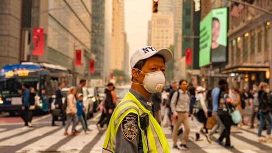 A traffic officer wears an N95 mask in Times Square amid a smoky haze from wildfires in Canada on June 7 in New York City. New York topped the list of most polluted major cities in the world on June 6 night, as smoke from the fires continues to blanket the East Coast.&nbsp;(Getty Images via AFP)