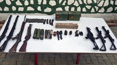 Security personnel display recovered snatched weapons during a Joint Combing Operations in sensitive areas both the Hills and Valley sectors of Manipur on Thursday. (ANI)