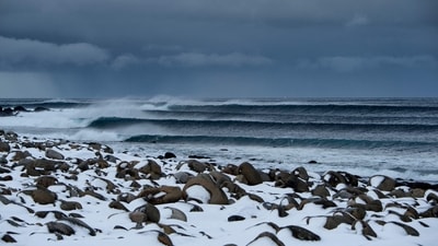 Surfing swell is photographed at snowy beach of Unstad, Norway on Lofoten Island, Arctic Circle, on March 9, 2016. (AFP)