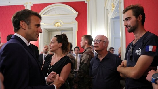 Henri, right, meets French President Emmanuel Macron in Annecy, French Alps, Friday. (AP)