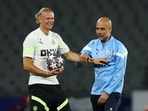 Manchester City manager Pep Guardiola with Erling Braut Haaland during training