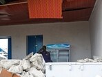 A Somali police officer uses his cell phone inside the rubble of the Pearl Beach Restaurant following an attack by Al Shabaab militants at the Liido beach in Mogadishu, Somalia June 10, 2023.