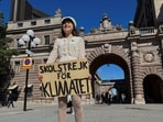 Greta Thunberg stands with a sign that reads, "School Strike for climate", outside the Swedish Parliament on the day of her weekly protest in Stockholm, Sweden.