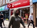 Pedestrians pass a Vodafone Group Plc store in Hove, UK, on Monday. Pedestrians pass a Vodafone Group Plc store in Hove, UK, on Monday.