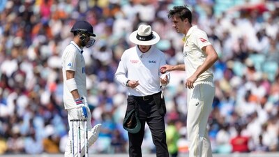 The umpire looks at the match ball watched by India's Shubman Gill, left and Australia's Pat Cummins (AP) The umpire looks at the match ball watched by India's Shubman Gill, left and Australia's Pat Cummins (AP)