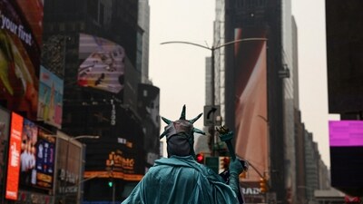 A street performer dressed as the Statue of Liberty stands in Times Square. (Reuters)