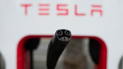 Tesla's EV charging connector is pictured at a charging station in Anaheim, California. (AP) Tesla's EV charging connector is pictured at a charging station in Anaheim, California. (AP)